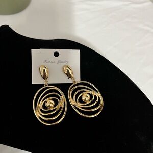 Gold Spiral Drop Earrings. it is plated in gold